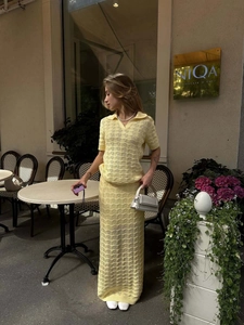 Detailed knit texture of pale yellow hollow-out Polo top and matching high-waisted skirt