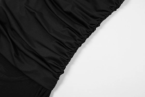 Detail shot of black ruched fabric texture on a sexy summer bodycon mesh dress