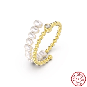 Detail of 925 sterling silver ring with white pearls and sparkling cubic zirconia