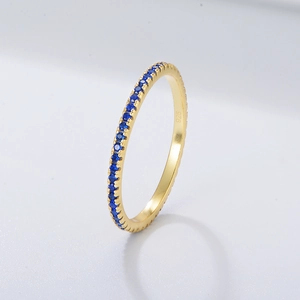 Macro shot of gold ring band featuring pavé-set blue zircons and S925 hallmark engraving