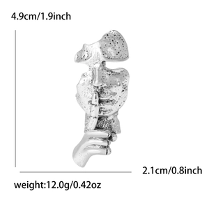 Detail view of silver abstract face shushing brooch showing 4.9cm height and 2.1cm width