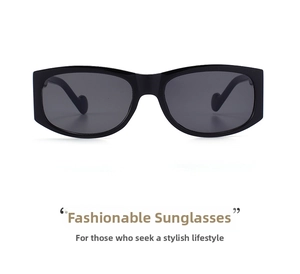Close-up of black rectangular sunglasses with polished frames and unique heart-shaped temple tips