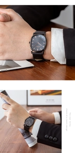 Detail of thin business watch with black alligator leather strap and rose gold markers