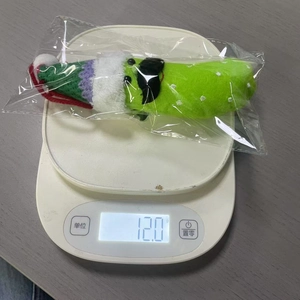 Weight measurement of 12 grams for the green plush keychain with sunglasses and hat