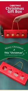 Detail of red Christmas paper gift box with clear window and golden handle rope