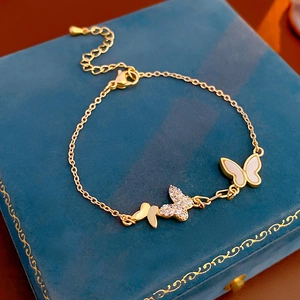 Close-up of gold plated butterfly bracelet with zircon stones and mother of pearl inlay