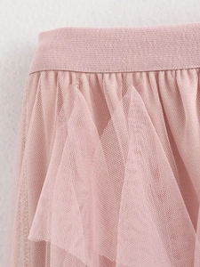 Detailed view of the elastic waistband and layered mesh texture on pink tulle skirt