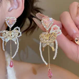 Elegant long tassel earrings with pink heart crystals, pearl arches and butterfly motifs