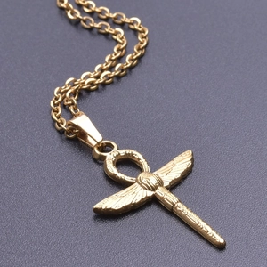 Macro shot of gold stainless steel Ankh cross pendant with wing details and sleek chain