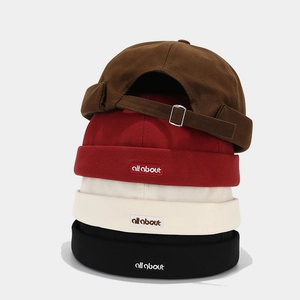 Retro canvas docker hats in multiple colors with embroidered labels and metal buckles