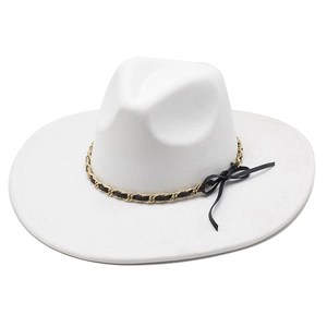 Detailed view of white wide brim fedora with gold metal chain and black leather bow