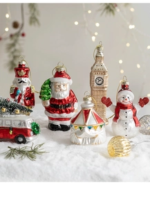 Detailed close-up of colorful glass Christmas ornaments on snow with warm bokeh lighting