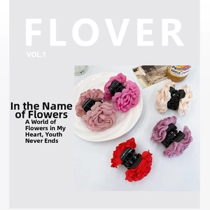 Detail view of five colors of fabric rose hair claws in cream, red, and purple hues