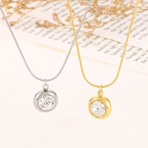 Detailed close-up of circular pendant necklaces with clear zircon on retro book pages
