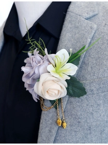 Détail d'une boutonnière élégante avec lys blanc et rose violette sur un revers de costume