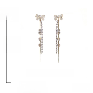 Detail view of long tassel bow earrings with 12cm length and 925 silver needle size info