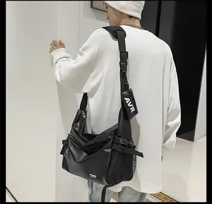 Detail view of large black crossbody bag with side mesh pocket and detachable small pouch