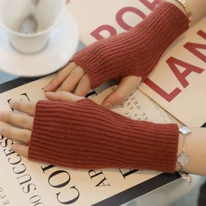 Thick brick red knit fingerless gloves with thumb hole on a lifestyle background