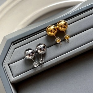 Minimalist round ball stud earrings in gold and silver finish with polished mirror surface