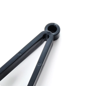 Micro shot of the black hinge joint of a portable eyeglass cleaning clip tool