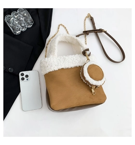 Detail of faux suede and lamb wool bucket bag with small round coin purse and chain strap