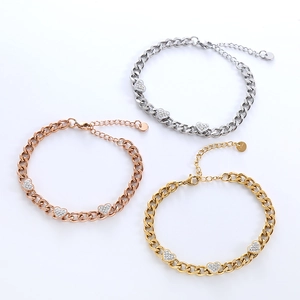 Three elegant heart-shaped charm bracelets in silver, gold, and rose gold with pavé crystals