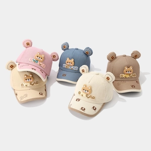 Detailed corduroy texture and 3D bear ear accents on children's baseball caps in multiple colors