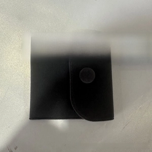 Detailed top view of 8cm square black velvet jewelry pouch with snap button and flap