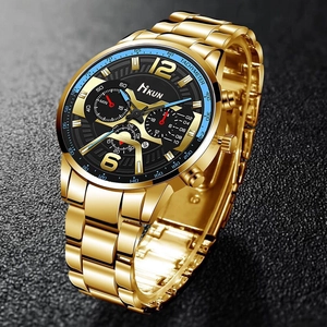 Close-up of gold stainless steel chronograph watch with black dial and tachymeter bezel