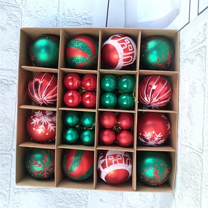 Top view of 16-compartment box with red and green Christmas balls in various patterns