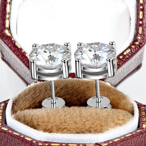 Close-up of D-color moissanite stud earrings in 925 silver in a red jewelry box