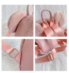 Detailed macro view of pink plush backpack straps with gold metal adjustment buckles