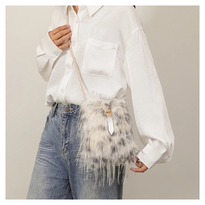 Detailed view of plush faux fur crossbody bag with speckled pattern and metal clasp