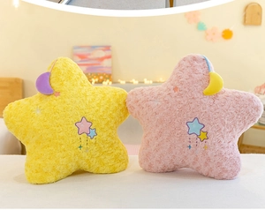 Detailed view of plush star pillows with rose texture and moon charm in pink and yellow
