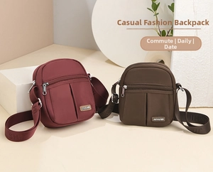Detail of adjustable patterned shoulder strap and zippers on durable nylon crossbody bags