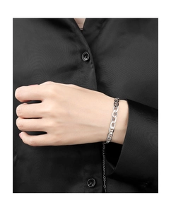 Detail of silver pig nose link bracelet with adjustable chain on a female model