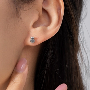 Elegant S925 sterling silver mini owl stud earrings worn on female model's earlobe
