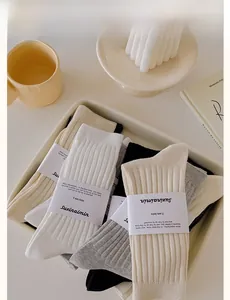 Detailed set of four ribbed cotton socks in beige, white, grey, and black colors