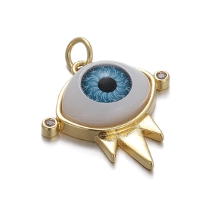 Macro detail of golden evil eye pendant with blue iris and three metal spikes