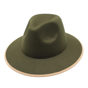Close-up of olive green wool fedora hat featuring beige ribbon binding and flat brim