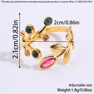 Detail of adjustable gold-tone leaf ring with colorful rhinestones on grey background