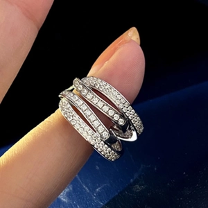 Detailed macro shot of multi-layer crisscross silver ring with pavé micro-zircons