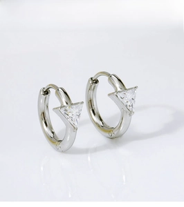 Detailed view of silver titanium steel hoop earrings with hanging triangle zircon crystals