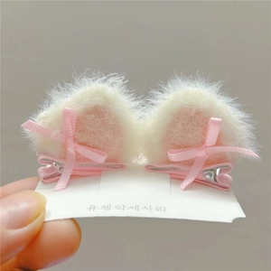 Pair of plush cat ear hair clips with pink ribbon bows for girls' hair styling