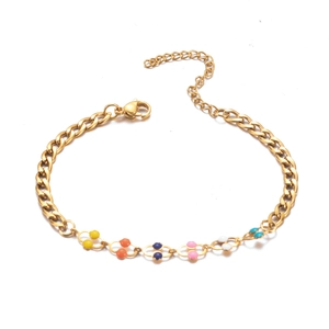 Detail of gold-plated curb chain bracelet featuring colorful enamel bead accents