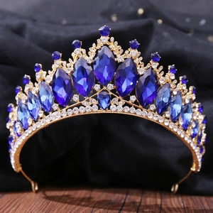 Detailed close-up of Baroque gold crown with deep blue gems and sparkling white crystals