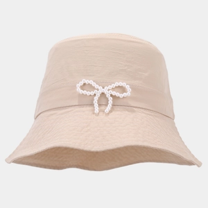 Detailed view of lightweight bucket hat with elegant pearl bow and textured fabric