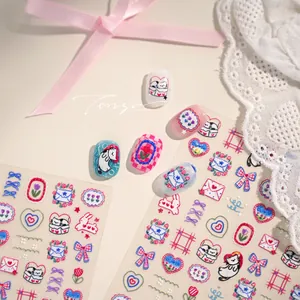 Detail view of cartoon 5D embossed nail stickers with cat and tulip floral designs