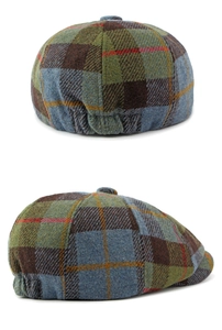 Detail of vintage plaid tweed flat cap with elastic band and wool texture pattern