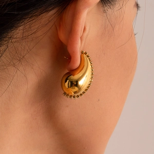 Chunky 18K gold-plated teardrop earrings with sparkling cubic zirconia on model
